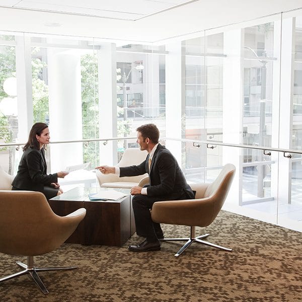 Man and woman sitting at a table in a sales meeting