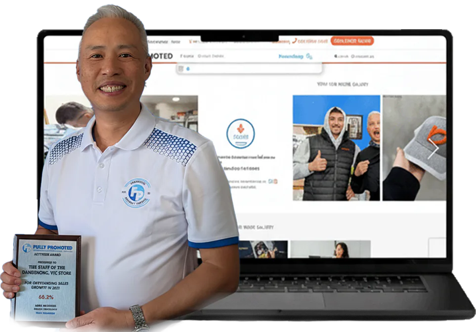 Andrew Leong holding an award plaque beside a laptop
