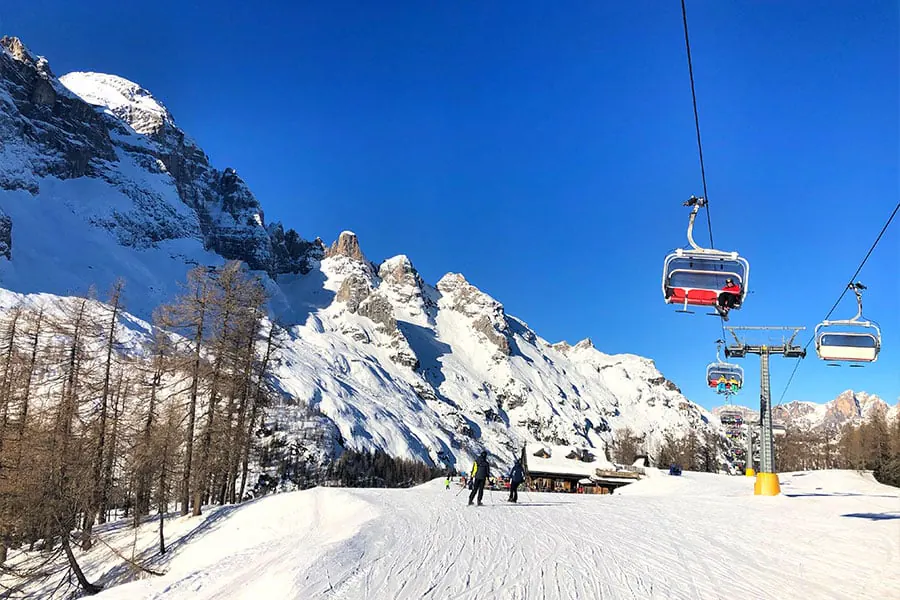 Ski resort chairlift above snow covered slopes