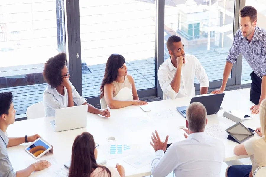 Team meeting around a table in a bright office